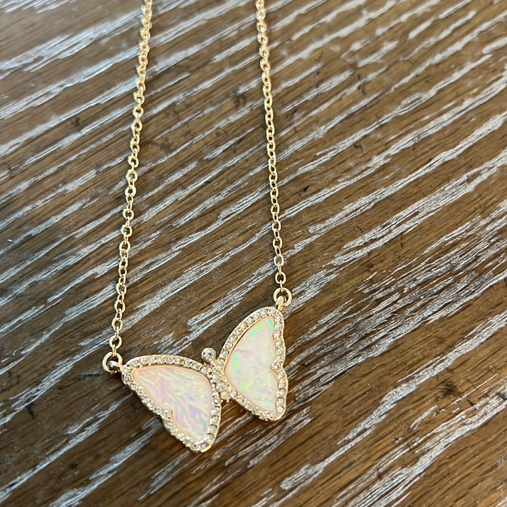 Gorgeous mother of pearl and jeweled butterfly necklace in gold.